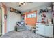 Charming bedroom with soft gray carpet, display shelves, and a cozy glider chair at 24748 E Layton Pl, Aurora, CO 80016