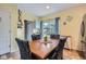 Dining room with a wood table, four chairs, yellow walls, light wood floors, and natural light at 24748 E Layton Pl, Aurora, CO 80016