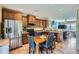 Open kitchen & dining area with wood cabinets, stainless steel appliances, and an adjacent living area at 24748 E Layton Pl, Aurora, CO 80016