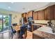 Bright kitchen and dining area with wood cabinets, stainless steel appliances, and natural light at 24748 E Layton Pl, Aurora, CO 80016