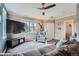 Comfortable living room features wood floors, flat-screen tv, neutral walls, and a ceiling fan at 24748 E Layton Pl, Aurora, CO 80016