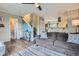 Stylish living area with wood flooring, adjacent staircase, and open access to the dining and kitchen areas at 24748 E Layton Pl, Aurora, CO 80016