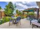 This backyard patio offers an outdoor dining area, pergola and seating for entertaining at 24748 E Layton Pl, Aurora, CO 80016