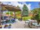 This spacious patio has an outdoor lounge area with a pergola covered with fabric at 24748 E Layton Pl, Aurora, CO 80016