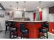 Finished basement bar area with seating, pendant lighting, cabinets, and a microwave at 6293 Braun Cir, Arvada, CO 80004