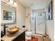 Bathroom featuring a tiled sink, toilet and glass enclosed shower at 6293 Braun Cir, Arvada, CO 80004