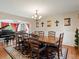 Formal dining room features a wooden table with seating for eight and chandelier lighting at 6293 Braun Cir, Arvada, CO 80004