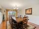 Formal dining room features a wooden table with seating for eight and chandelier lighting at 6293 Braun Cir, Arvada, CO 80004