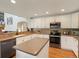 Well-equipped kitchen featuring white cabinetry, stainless steel appliances, and ample counter space at 6293 Braun Cir, Arvada, CO 80004