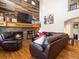 Cozy living room featuring a stone fireplace with wood mantel and a comfortable recliner at 6293 Braun Cir, Arvada, CO 80004