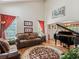 Bright living room features high ceilings, hardwood floors, a piano, and comfortable seating at 6293 Braun Cir, Arvada, CO 80004