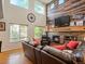 Bright living room with a fireplace, wood accent wall, large windows and a high ceiling at 6293 Braun Cir, Arvada, CO 80004