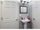 Traditional powder room with a pedestal sink, framed mirror, and towel ring at 6293 Braun Cir, Arvada, CO 80004