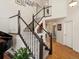 Staircase with carpet and a hardwood landing, located near the main entry at 6293 Braun Cir, Arvada, CO 80004