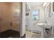 Cozy bathroom with standing sink, window, decorative plant, and shower stall at 721 Park Ln, Lakewood, CO 80214