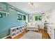 Bright bedroom with hardwood floors, natural light, and a cozy atmosphere, perfect for children or guests at 721 Park Ln, Lakewood, CO 80214