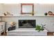 Bright living room fireplace with a white painted brick surround and decorative mantle at 721 Park Ln, Lakewood, CO 80214