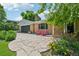 A welcoming home with a stone pathway, flowering plants, and inviting red chairs on the front porch at 721 Park Ln, Lakewood, CO 80214