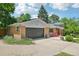 Exterior view of charming brick home, green lawn, mature trees, and attached garage at 721 Park Ln, Lakewood, CO 80214