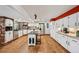 Spacious kitchen with white cabinetry, stainless steel appliances, and a center island at 721 Park Ln, Lakewood, CO 80214