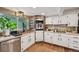 Bright kitchen with white cabinets, stainless steel appliances, and a copper sink that adds warmth to the space at 721 Park Ln, Lakewood, CO 80214