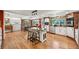 Open layout of kitchen and dining area with a large island and hardwood floors at 721 Park Ln, Lakewood, CO 80214