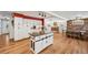 Spacious kitchen with island, white cabinets, and view to the dining room and living space at 721 Park Ln, Lakewood, CO 80214