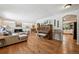 Spacious living room with hardwood floors, white brick fireplace, and comfortable neutral furniture at 721 Park Ln, Lakewood, CO 80214