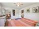 Spacious main bedroom showcasing hardwood floors, mirrored closet doors, and a light-filled ambiance at 721 Park Ln, Lakewood, CO 80214