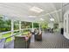 Large covered patio features comfortable seating, a dining table, and a grill, creating the perfect outdoor living space at 721 Park Ln, Lakewood, CO 80214