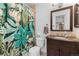 Bathroom with floral shower curtain, vanity with decorative mirror and granite countertop at 980 S Dahlia St # A, Denver, CO 80246