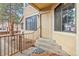 Exterior door with porch featuring a concrete stairway and black metal railing at 980 S Dahlia St # A, Denver, CO 80246