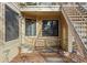 Exterior entrance featuring a covered porch with unique tile flooring and convenient stair access at 980 S Dahlia St # A, Denver, CO 80246