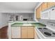 Open kitchen featuring breakfast bar, white appliances and wood-style cabinets at 980 S Dahlia St # A, Denver, CO 80246