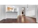 Open-concept living space featuring hardwood floors, kitchen, and bathroom views at 980 S Dahlia St # A, Denver, CO 80246