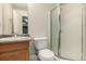 Classic bathroom featuring a single sink vanity, toilet, and glass shower enclosure in a neutral color palette at 10172 Woodrose Ln, Highlands Ranch, CO 80129
