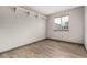 Bright bedroom with a large window for natural light, with overhead shelving, and light wood flooring at 10172 Woodrose Ln, Highlands Ranch, CO 80129