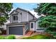 Beautiful home featuring gray siding, brick details, and a cozy front entrance with steps and landscaping at 10172 Woodrose Ln, Highlands Ranch, CO 80129