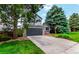 Lovely two-story home with a driveway and mature landscaping, including lush trees and a green lawn at 10172 Woodrose Ln, Highlands Ranch, CO 80129