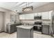 Stylish kitchen featuring granite countertops, stainless steel appliances, and an island with hanging light at 10172 Woodrose Ln, Highlands Ranch, CO 80129
