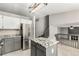 Spacious kitchen with granite counters, stainless steel appliances, island, and access to the stairs at 10172 Woodrose Ln, Highlands Ranch, CO 80129