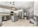 Modern kitchen with stainless steel appliances, gray cabinets, granite counters and center island at 10172 Woodrose Ln, Highlands Ranch, CO 80129