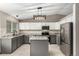 Well-equipped kitchen featuring stainless steel appliances, gray cabinetry, and a granite countertop island at 10172 Woodrose Ln, Highlands Ranch, CO 80129