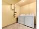 Dedicated laundry area with washer and dryer hookups, featuring tile flooring and ample space for laundry tasks at 10172 Woodrose Ln, Highlands Ranch, CO 80129