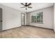 Bright main bedroom with ceiling fan, wood flooring, and ensuite access at 10172 Woodrose Ln, Highlands Ranch, CO 80129