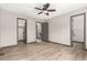 Spacious main bedroom with wood floors, ceiling fan, and walk in closet at 10172 Woodrose Ln, Highlands Ranch, CO 80129