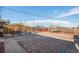 Sprawling backyard with playground equipment, stone features, a bench and a fence at 7066 Jennie Dr, Denver, CO 80221