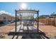 Backyard with a pergola over a patio set and a small rock garden at 7066 Jennie Dr, Denver, CO 80221