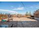 Spacious backyard features gravel landscaping, a patio with a pergola, and a wooden fence for added privacy at 7066 Jennie Dr, Denver, CO 80221
