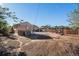 Overview of a backyard with a patio set under a pergola, small garden and a brick house at 7066 Jennie Dr, Denver, CO 80221